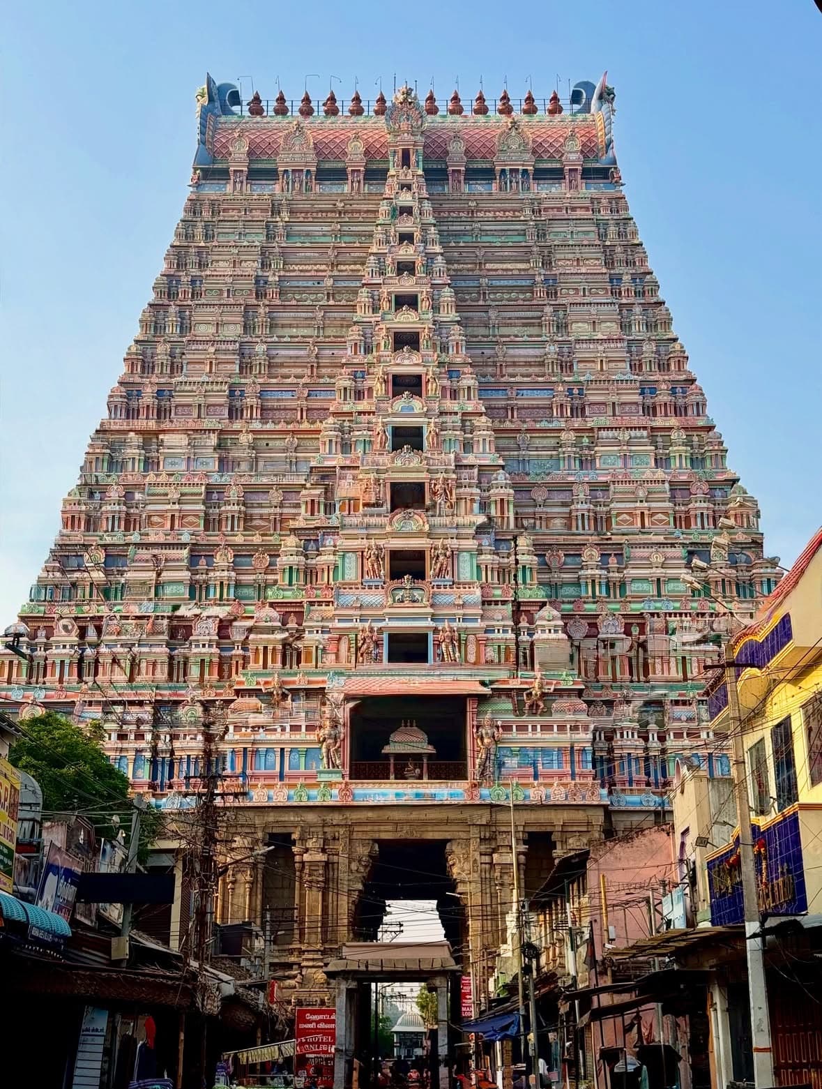 The painted tiers of the Ranganathaswamy temple's rajagopuram rising over the street at Srirangam.